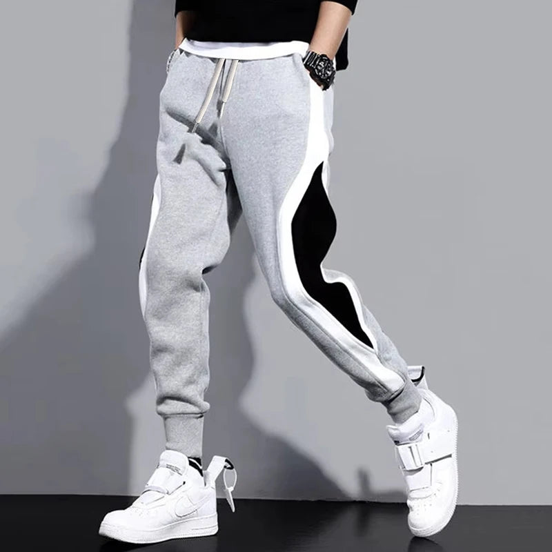 Pantalones anchos informales y sueltos para hombre, pantalones deportivos de retales de nueve puntos, cuerda elástica, transpirables, con lazo para los pies, otoño